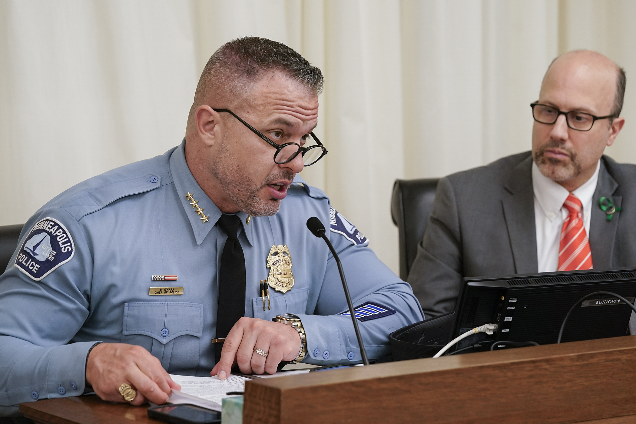 Minneapolis Police Chief Brian O'Hara testifies March 24 before the House public safety committee in support of HF3407. The bill to prohibit the sale and possession of ghost guns is sponsored by Rep. Dave Pinto, right. (Photo by Michele Jokinen)